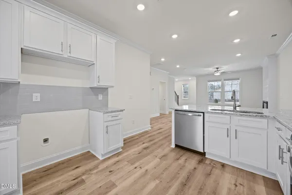 a kitchen with white cabinets and white appliances