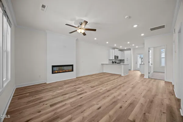 a view of an empty room with a kitchen