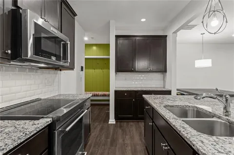 a kitchen with a stove microwave and sink
