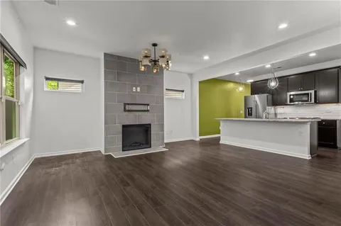 a view of a kitchen with a sink and a fireplace