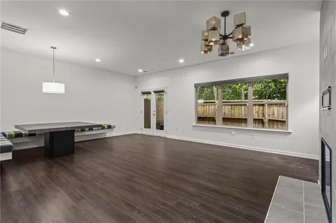 a view of kitchen with furniture large window and wooden floor