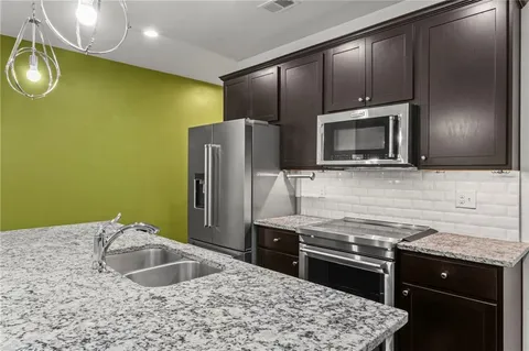 a kitchen with a sink stove and microwave