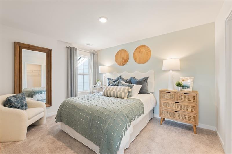 1707 Harper Lily Lane Lawrenceville, GA 30043 - Photo 17 of 43 a bedroom with a bed and a window