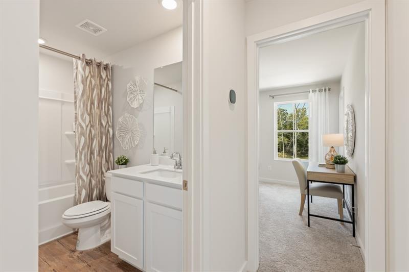 1707 Harper Lily Lane Lawrenceville, GA 30043 - Photo 22 of 43 a bathroom with a toilet a sink and a mirror