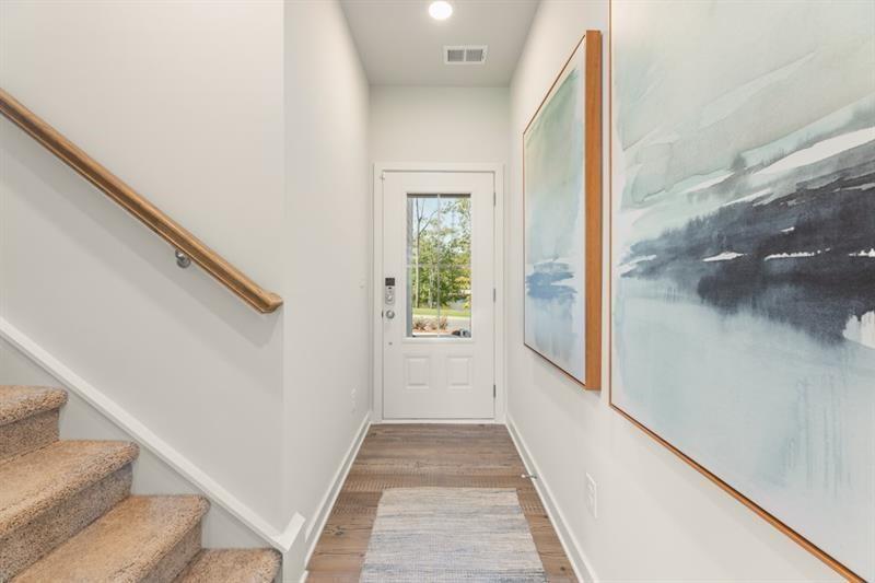1707 Harper Lily Lane Lawrenceville, GA 30043 - Photo 23 of 43 a view of a hallway with wooden floor and staircase