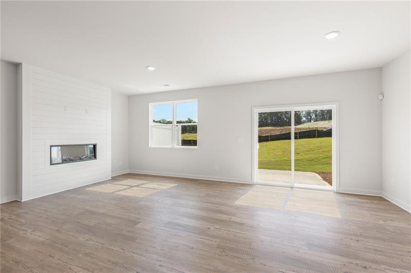 1707 Harper Lily Lane Lawrenceville, GA 30043 - Photo 27 of 43 a view of an empty room with a window and wooden floor