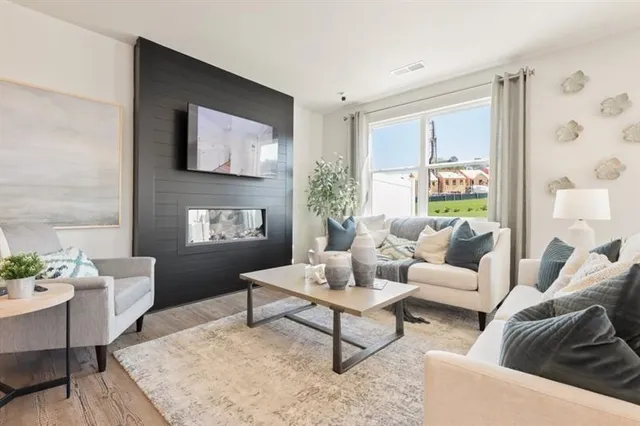 a dining room with furniture a large window and stainless steel appliances