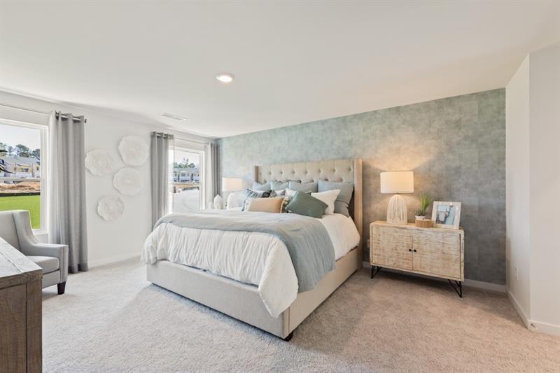 1707 Harper Lily Lane Lawrenceville, GA 30043 - Photo 42 of 43 a spacious bedroom with a bed and a couch