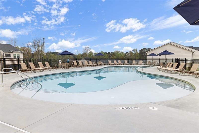 1707 Harper Lily Lane Lawrenceville, GA 30043 - Photo 7 of 43 a view of a swimming pool with a terrace