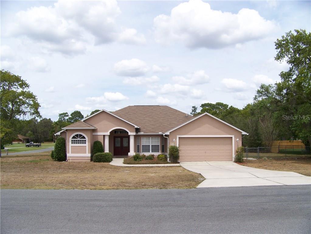 12011 Cromwell Way Spring Hill, FL 34609 - Photo 1 of 1 a view of a house with a yard and large trees