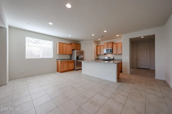 a kitchen with stainless steel appliances granite countertop a refrigerator and a stove top oven