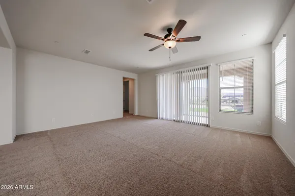 a view of a livingroom with a ceiling fan and window