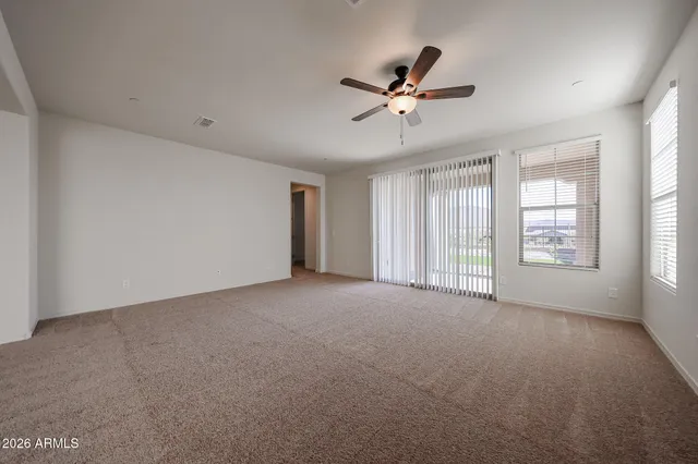 a view of a livingroom with a ceiling fan and window