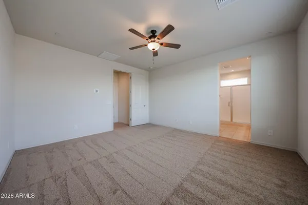 a view of an empty room with a ceiling fan