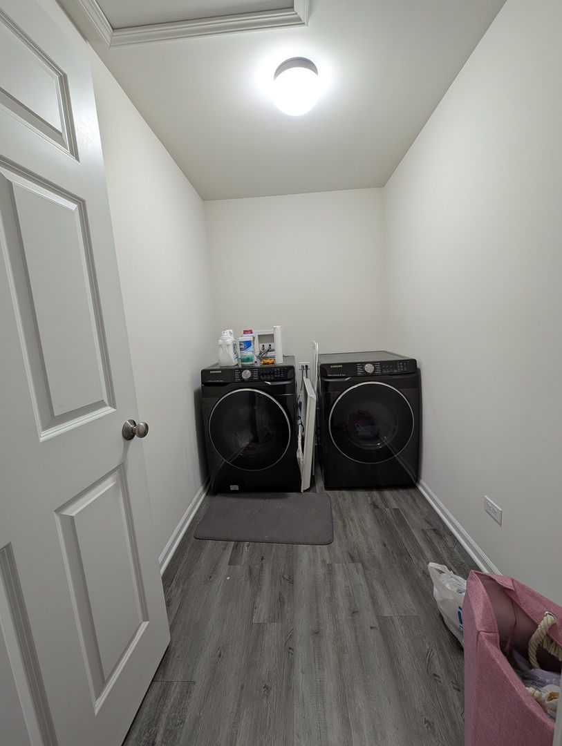 3759 St James Court Elgin, IL 60124 - Photo 16 of 28 a room with two washing machine with wooden floor