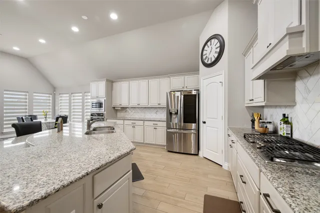 a kitchen with a stove a refrigerator and a sink