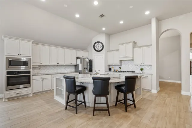 a kitchen with a sink cabinets and wooden floor