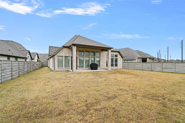 a view of a house with pool and sitting area