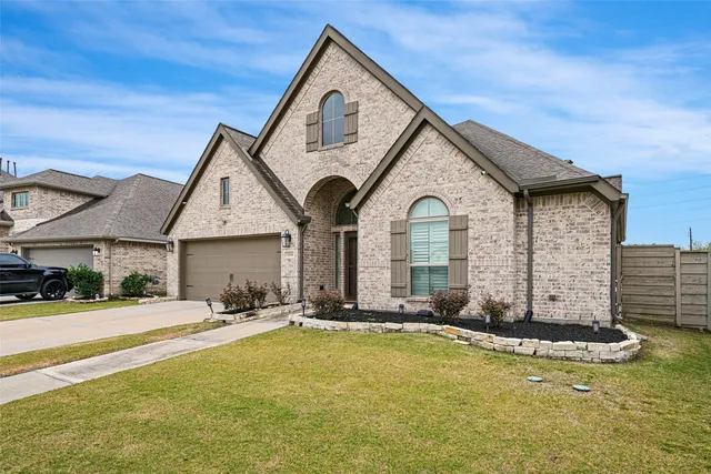 a view of a house with yard and sitting area