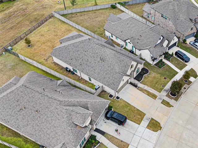 an aerial view of residential houses with outdoor space