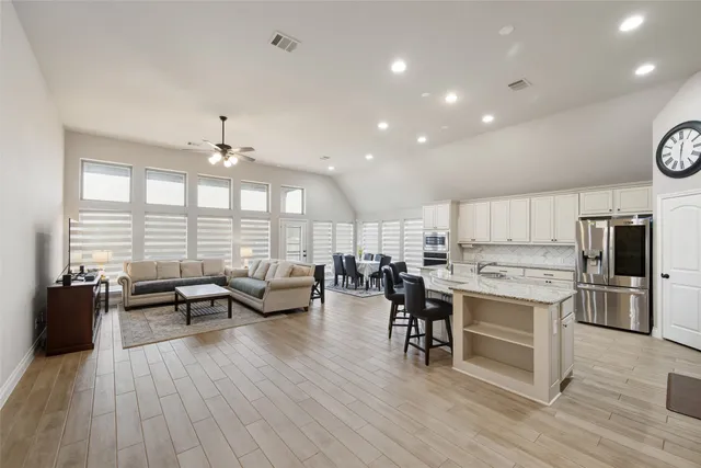 a large kitchen with lots of counter space and stainless steel appliances