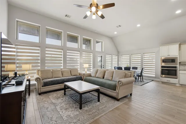 a living room with furniture a fireplace and a flat screen tv