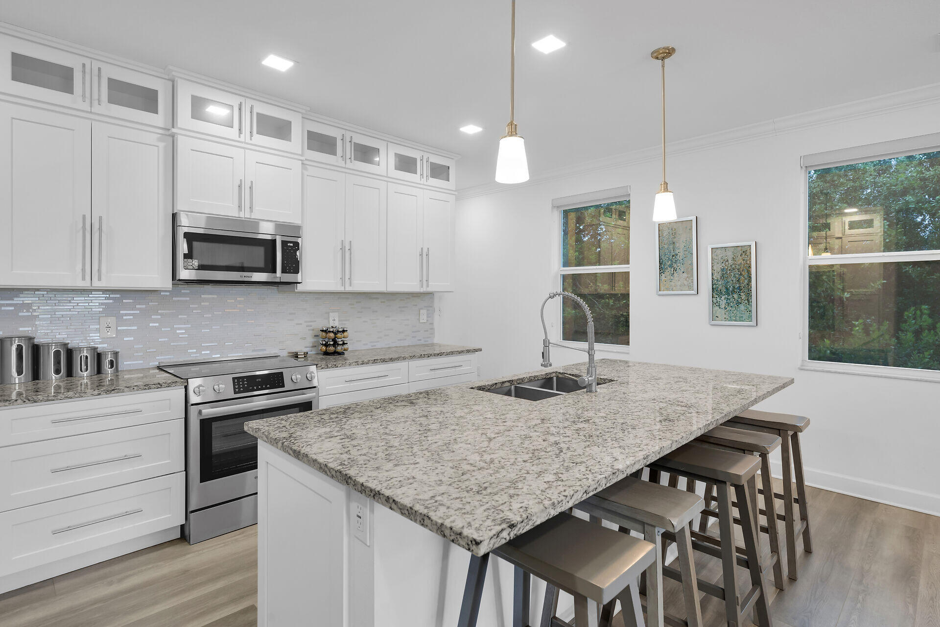 451 Sombrero Beach Road Marathon, FL 33050 - Photo 13 of 55 a kitchen with granite countertop kitchen island a stove a table and chairs in it