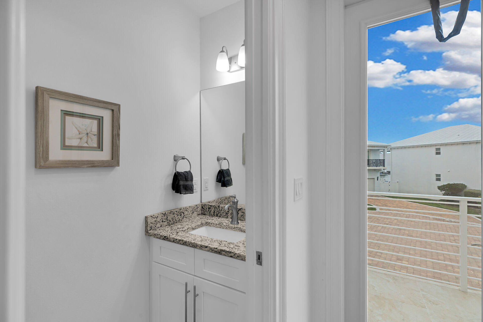 451 Sombrero Beach Road Marathon, FL 33050 - Photo 29 of 55 a bathroom with a granite countertop sink and a mirror
