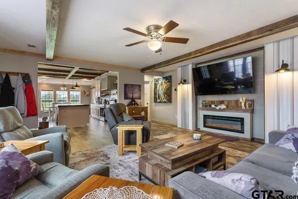 a living room with furniture fireplace and flat screen tv