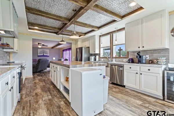 a kitchen with cabinets a sink and appliances