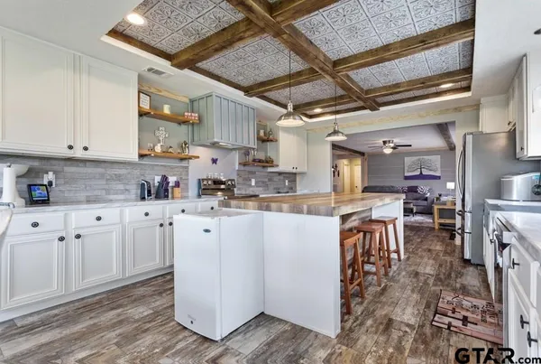 a kitchen with appliances cabinets and a table