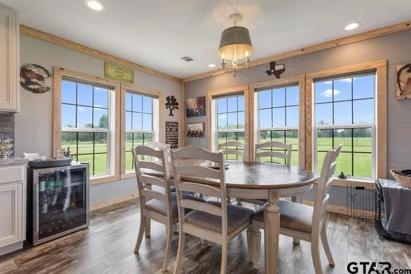 a view of a dining room with furniture large windows and wooden floor