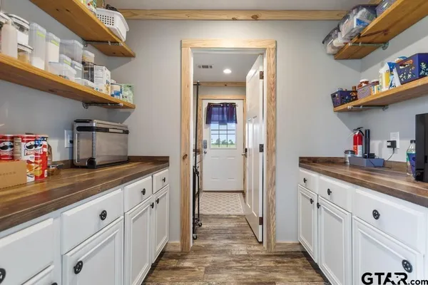 a kitchen with cabinets and a window