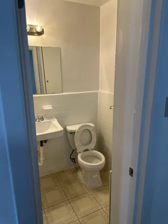 a bathroom with a toilet and a mirror