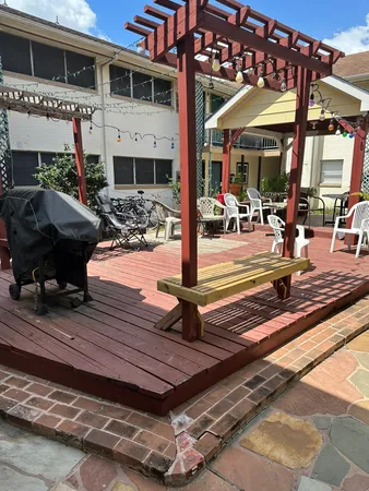 a view of a patio with table and chairs potted plants