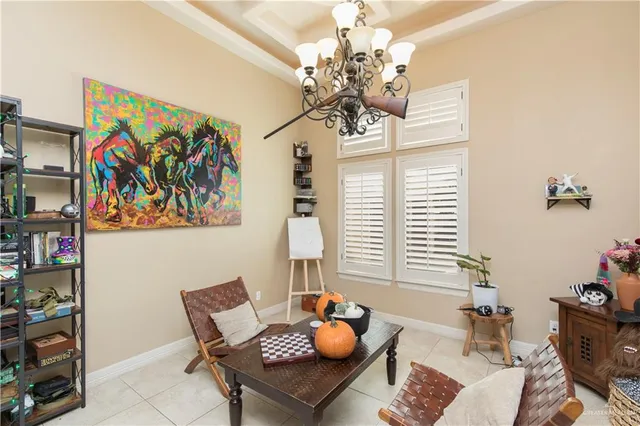 a living room with furniture and a chandelier