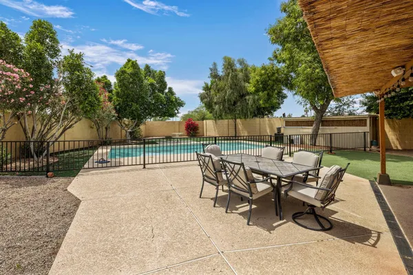 a view of a backyard with sitting area