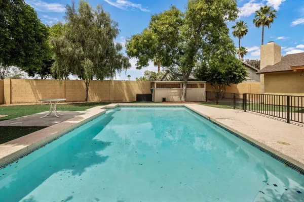 a view of a backyard with a small pool