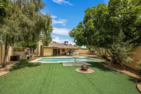 a front view of a house with a yard and trees