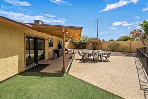 a view of a patio with dining table and chairs with a patio