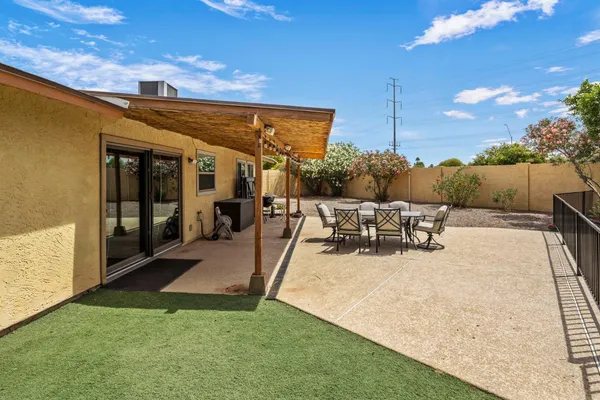 a view of a patio with dining table and chairs with a patio