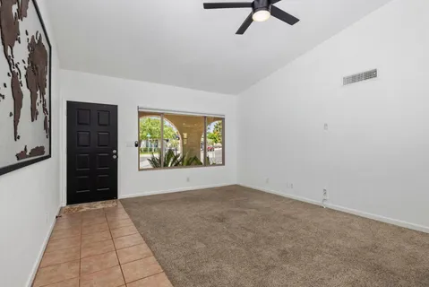 an empty room with windows and closet