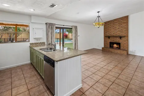 an open kitchen with sink and breakfast area
