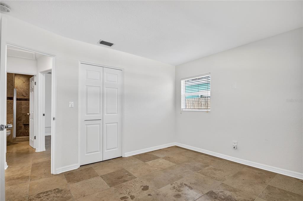 13440 1st Street East Madeira Beach, FL 33708 - Photo 21 of 44 an empty room with a natural light