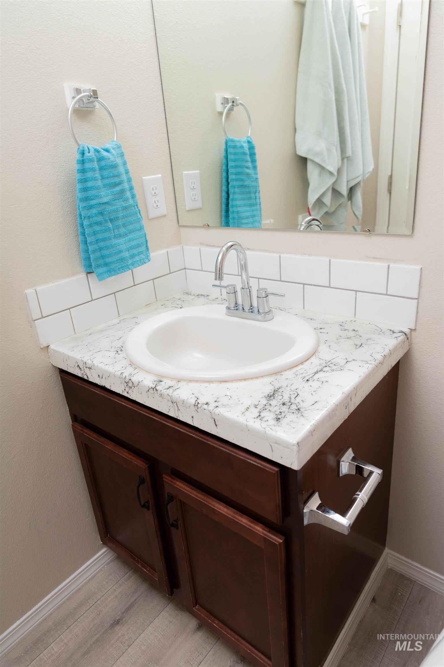 16919 Abram Avenue Caldwell, ID 83607 - Photo 21 of 32 Bathroom with vanity, light wood finished floors, and a textured wall