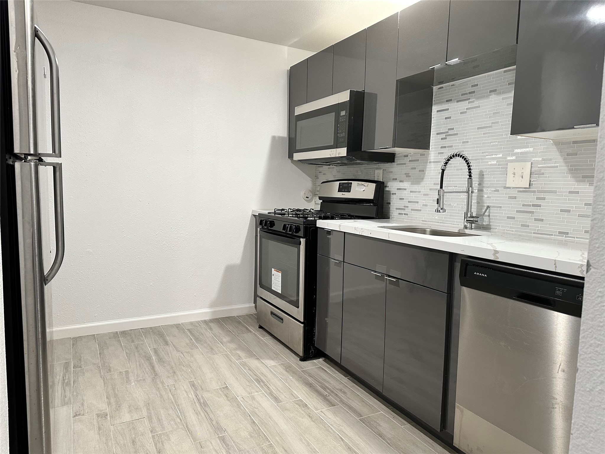 4802 Elser Street Houston, TX 77009 - Photo 11 of 21 a view wooden cabinets and a sink