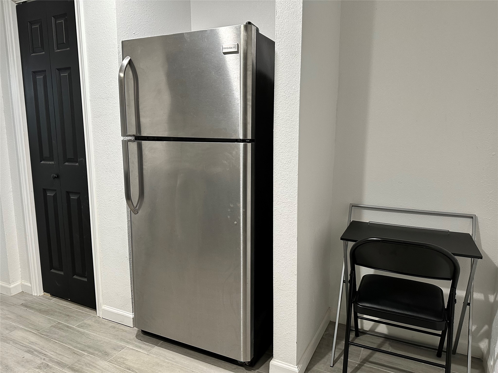 4802 Elser Street Houston, TX 77009 - Photo 13 of 21 a view of a refrigerator in kitchen and an empty room