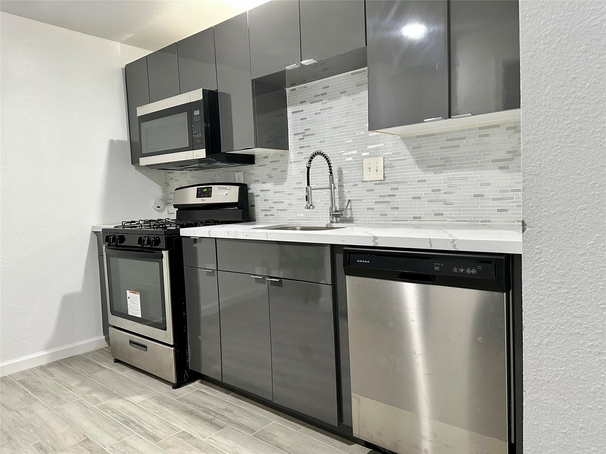 4802 Elser Street Houston, TX 77009 - Photo 14 of 21 a kitchen with stainless steel appliances granite countertop a sink and a microwave