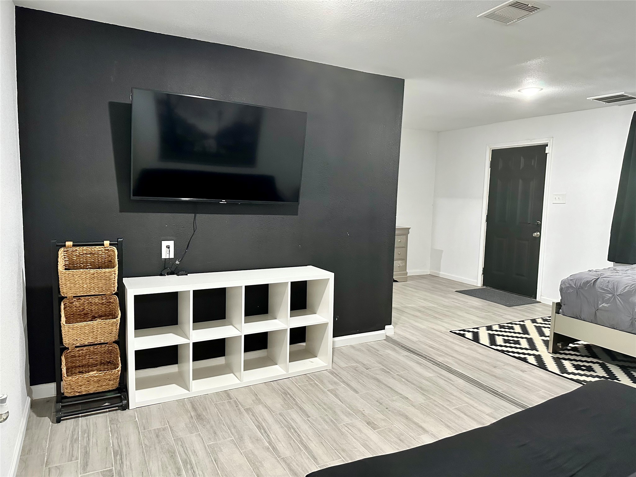 4802 Elser Street Houston, TX 77009 - Photo 3 of 21 a bedroom with a bed and a television in it