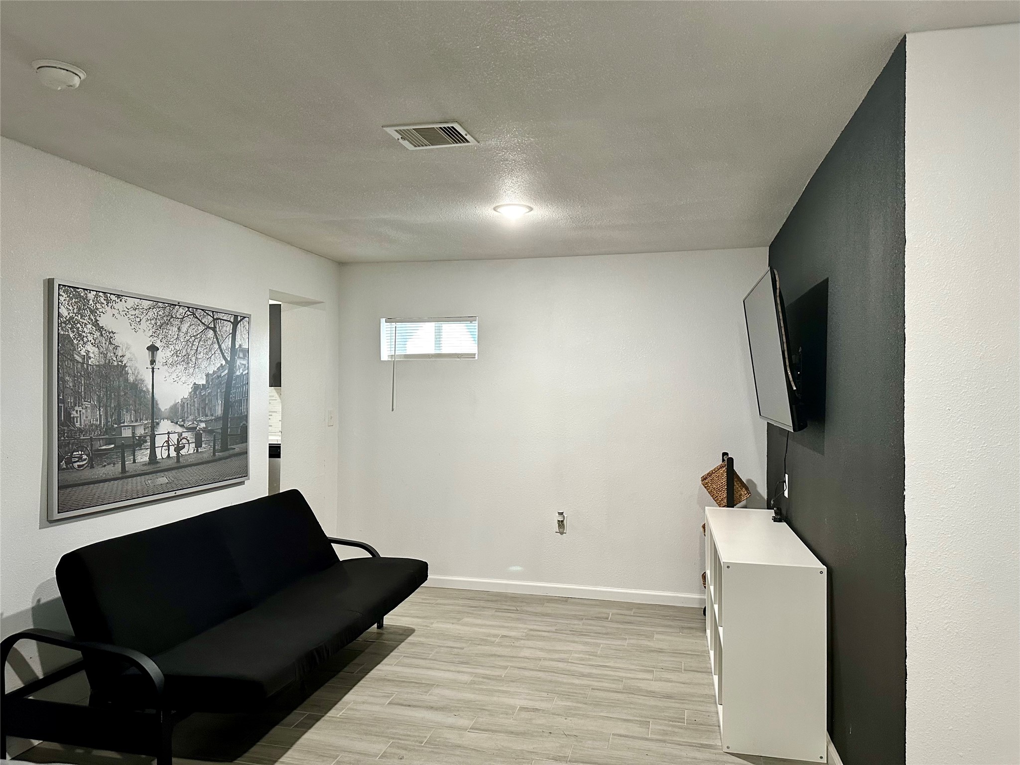4802 Elser Street Houston, TX 77009 - Photo 6 of 21 a living room with furniture and a black refrigerator